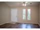 Inviting living room featuring wood-look floors, a ceiling fan, and ample natural light at 5058 Cimarron Dr, Lakeland, FL 33813