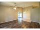 Open-concept living area featuring wood-look floors, tile flooring, and sliding doors at 5058 Cimarron Dr, Lakeland, FL 33813