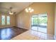 Well-lit living space featuring wood-look and tile flooring, and access to the screened patio at 5058 Cimarron Dr, Lakeland, FL 33813