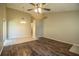Spacious living area featuring wood-look floors, tile flooring, and ceiling fans at 5058 Cimarron Dr, Lakeland, FL 33813