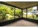 View of a screened in porch overlooking a beautifully landscaped backyard at 5058 Cimarron Dr, Lakeland, FL 33813