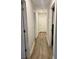 Long hallway with light walls and wood flooring at 520 Green Cir, Fort Meade, FL 33841