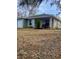 Gray house with covered porch and landscaping at 520 Green Cir, Fort Meade, FL 33841