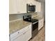 Modern kitchen with white cabinets and granite countertops at 520 Green Cir, Fort Meade, FL 33841