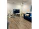 Living room with blue sofa, wood-look floors, and coastal decor at 520 Green Cir, Fort Meade, FL 33841