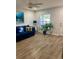 Living room with a blue sofa and coastal decor at 520 Green Cir, Fort Meade, FL 33841
