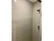 Modern shower with gray tile walls and a glass door at 520 Green Cir, Fort Meade, FL 33841