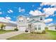 Two-story house with gray siding, two-car garage, and landscaped yard at 5460 Siltstone St, Lakeland, FL 33811