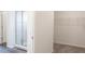 Bathroom showcases a tiled shower, framed mirror and the doorway to the walk-in closet at 565 Sw 77Th Cir, Ocala, FL 34474