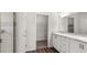 Bright bathroom with double sink vanity, framed mirror, walk-in closet and tiled shower at 565 Sw 77Th Cir, Ocala, FL 34474