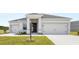 Charming single-Gathering home featuring a well-manicured lawn, a two-car garage, and a welcoming front entrance at 565 Sw 77Th Cir, Ocala, FL 34474