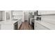 Updated kitchen with white cabinets, modern stainless steel appliances and luxury vinyl plank floors at 565 Sw 77Th Cir, Ocala, FL 34474