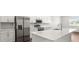 Modern kitchen showcasing stainless steel appliances, quartz countertops, and a center island at 565 Sw 77Th Cir, Ocala, FL 34474