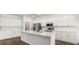 Modern kitchen with an island, stainless steel appliances, and white cabinets at 565 Sw 77Th Cir, Ocala, FL 34474