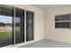A covered patio includes sliding glass doors and a window that allows natural light at 565 Sw 77Th Cir, Ocala, FL 34474