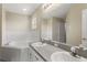 Bathroom with double sinks, corner tub, and separate shower at 8183 Westmont Terrace Dr, Lakeland, FL 33810