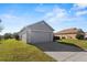 Two-car garage with ample parking space and a well-kept lawn at 8183 Westmont Terrace Dr, Lakeland, FL 33810