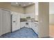 Kitchen features white cabinets, blue tile floor and stainless steel appliances at 8183 Westmont Terrace Dr, Lakeland, FL 33810