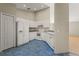 Well-lit kitchen with white cabinets, standard appliances, and blue tile flooring at 8183 Westmont Terrace Dr, Lakeland, FL 33810