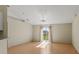 Bright living room with vaulted ceiling, wood floors, and sliding glass doors to the backyard at 8183 Westmont Terrace Dr, Lakeland, FL 33810