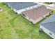 Aerial view of home showcasing backyard, grassy area, and screened patio at 1034 Corso Dr, Winter Haven, FL 33884