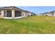 Large backyard with grassy area and screened patio at 1034 Corso Dr, Winter Haven, FL 33884