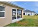 Backyard view of home with screened porch and grassy area at 1034 Corso Dr, Winter Haven, FL 33884
