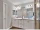 Double vanity bathroom with a large mirror and walk-in shower at 1034 Corso Dr, Winter Haven, FL 33884