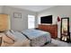 Bedroom with a queen bed and dresser at 1034 Corso Dr, Winter Haven, FL 33884