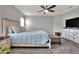 Spacious bedroom with a large bed, dresser, and TV at 1034 Corso Dr, Winter Haven, FL 33884
