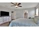 Bright bedroom featuring a large bed and ensuite bathroom access at 1034 Corso Dr, Winter Haven, FL 33884