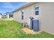 View of the home's exterior, highlighting water softener and AC unit at 1034 Corso Dr, Winter Haven, FL 33884