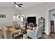 Living room features vaulted ceiling, hardwood floors, and a large TV at 1034 Corso Dr, Winter Haven, FL 33884