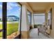 Screened porch with two adirondack chairs, overlooking the yard at 1034 Corso Dr, Winter Haven, FL 33884