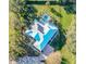 House with blue metal roof, solar panels, and pool at 111 Arbor Way, Auburndale, FL 33823