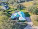Home with metal roof and paved driveway, aerial view at 111 Arbor Way, Auburndale, FL 33823