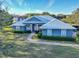 Single-story home with metal roof and manicured lawn at 111 Arbor Way, Auburndale, FL 33823