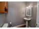Clean bathroom with pedestal sink and wood flooring at 111 Arbor Way, Auburndale, FL 33823