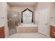 Bathroom with soaking tub and corner shower at 111 Arbor Way, Auburndale, FL 33823