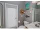 Small bathroom with toilet, sink, and exterior access at 111 Arbor Way, Auburndale, FL 33823
