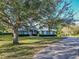 Beautiful home with a large tree and brick driveway at 111 Arbor Way, Auburndale, FL 33823