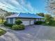 Gray house with two-car garage and paved driveway at 111 Arbor Way, Auburndale, FL 33823