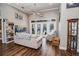 Spacious Gathering room featuring hardwood floors, a large window, and comfortable seating at 111 Arbor Way, Auburndale, FL 33823