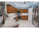Modern kitchen with stainless steel appliances and light wood cabinets at 111 Arbor Way, Auburndale, FL 33823