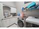 Clean and spacious laundry room with storage and countertop at 111 Arbor Way, Auburndale, FL 33823