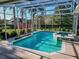 Inviting screened pool and spa with lush landscaping at 111 Arbor Way, Auburndale, FL 33823