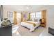 Main bedroom with a king-size bed, mustard yellow accents and ample natural light at 1335 Robinhood S Ln, Lakeland, FL 33813