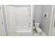 Bathroom with a shower/tub combo, toilet and white tile at 1520 Royal Forest Loop, Lakeland, FL 33811