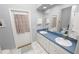 Double vanity bathroom with blue countertop and access to backyard at 1520 Royal Forest Loop, Lakeland, FL 33811