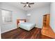 Bedroom with double bed, wood floors, ceiling fan, and built-in shelving at 1520 Royal Forest Loop, Lakeland, FL 33811